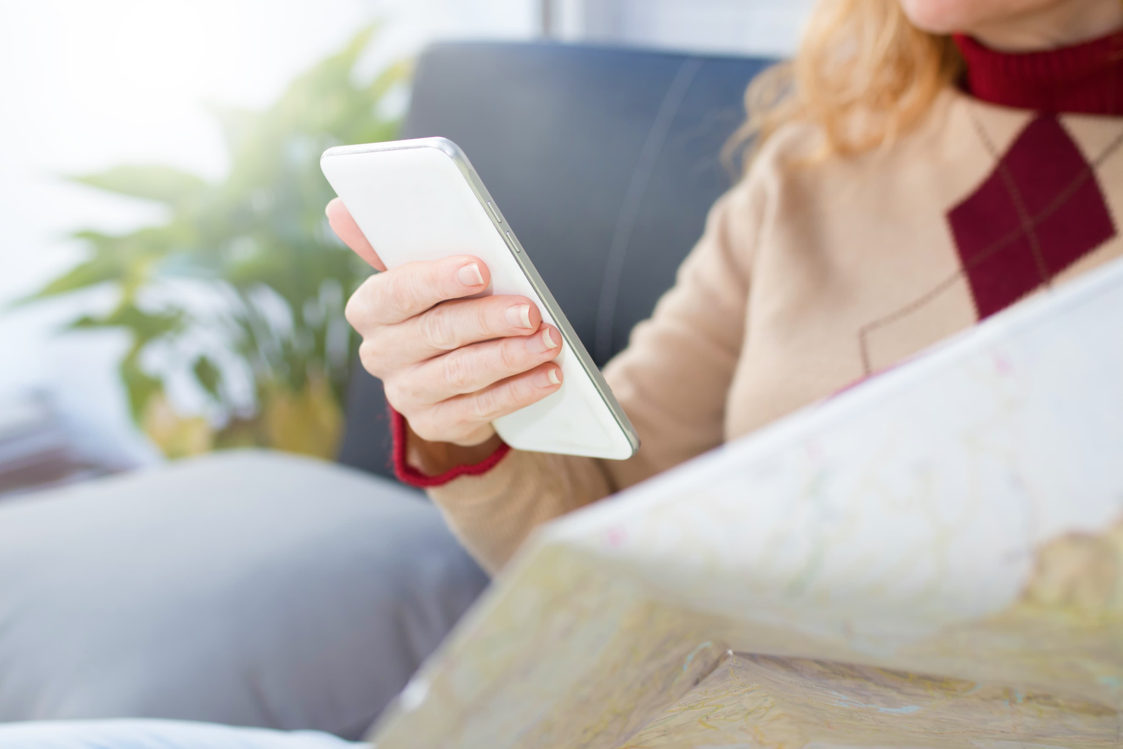 Hand on a map or phone showing locations