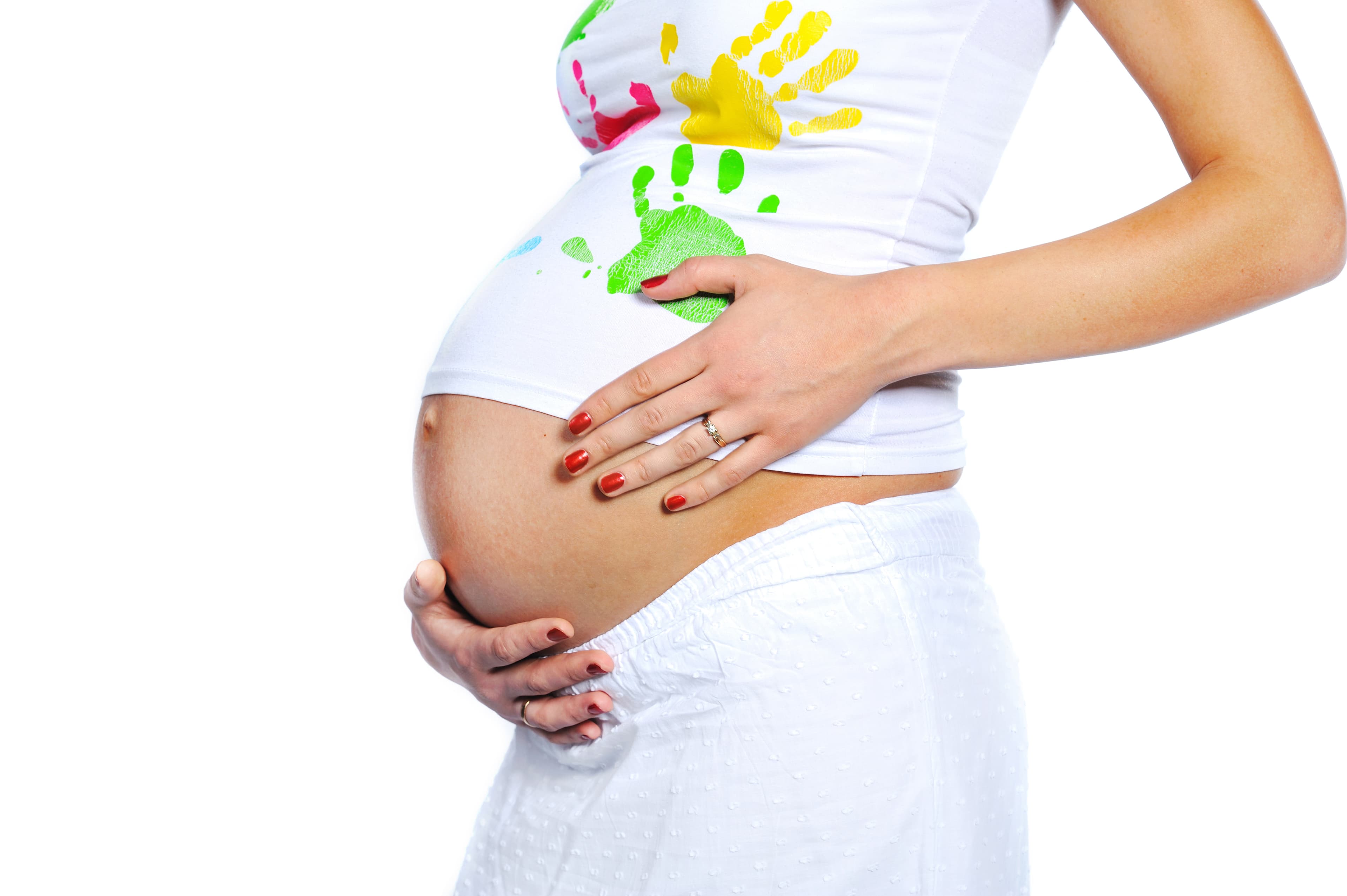 Pregnant person cradling their belly, painted handprints on the shirt